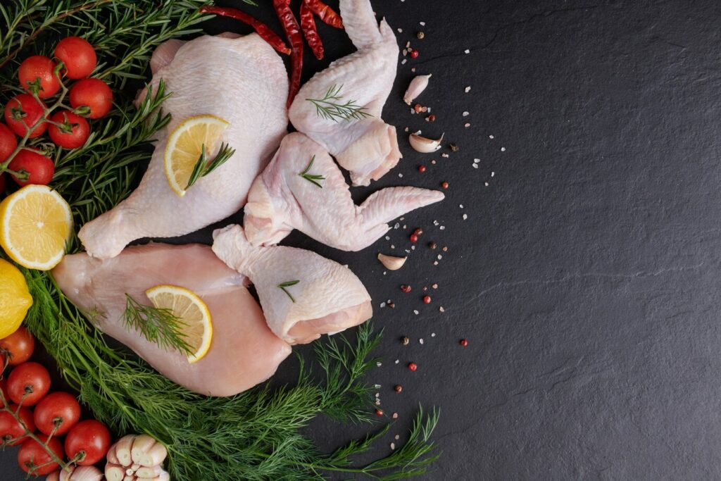 raw-chicken-fillet-with-garlic-pepper-rosemary-wooden-chopping-board_1150-37785